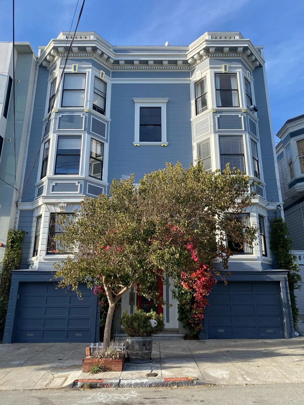 Blue San Francisco house with white trim and stacked bay windows